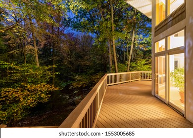 Large Composite Deck On A Luxury Home In The Woods Photographed At Night.  Concepts Could Include Architecture, Design, Outdoor Living, Luxury Living, Nature, Others.