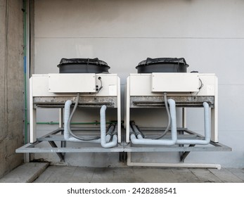 The large compressor unit of the air conditioning system located behind the power supply station of the monorail station., front view with the copy space.