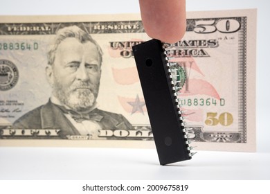 Large Computer Chip Placed Next To 50 US Dollar Banknote. Concept For Investment In Semiconductor Industry And Golbal Chip Shortage.