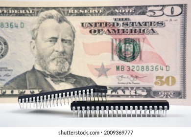 Large Computer Chips Placed Next To 50 US Dollar Banknote. Concept For Investment In Semiconductor Industry And Golbal Chip Shortage.