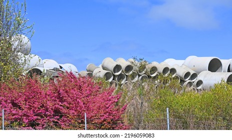 Large Concrete Drainage Pipes Set Against A Blue Sky