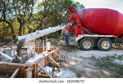 Large Concrete Mixing Truck Pouring Concrete To Small Water House Foundation. Motion Image.