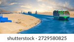 Large container ship, accompanied by tugboat, passing through the Suez Canal in Egypt.