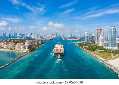 Large Container Ship Entering Harbor and Miami City on Sunny Day, USA. Aerial View.