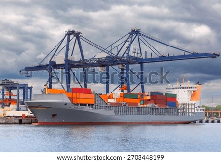 Large container ship moored at Baltic Container Terminal in Gdynia, Poland under ship-to-shore cranes