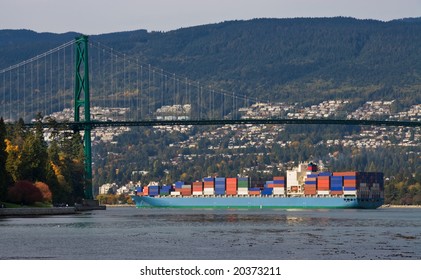 Large container ship is passing  under the Lions Gate  Bridge in Vancouver, Canada.