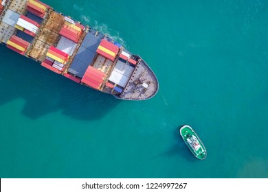 Large Container Ship Pulled Into Port By A Tugboat - Top Down Aerial Image