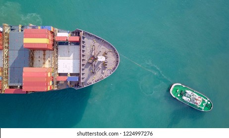 Large Container Ship Pulled Into Port By A Tugboat - Top Down Aerial Image