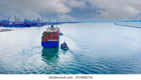 A large container ship for transporting goods at industrial import-export port transport goods around world, global transportation and logistic business.Oversea international Business.