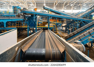 Large conveyor lines plant for sorting and processing household waste. - Shutterstock ID 2264200699