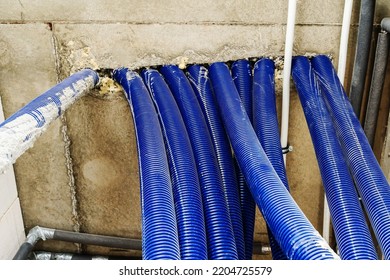 Large Corrugations Hang From The Ceiling In The Boiler Room For The Safe Installation Of Plumbing. Construction Of Water Supply And Heating Lines In A Private House. Close-up