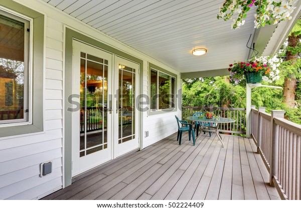 Large covered
porch with railings ,outdoor seats, flower pots and turned on
lights on the ceiling. Northwest,
USA