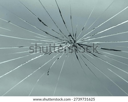 Large Cracked Front Car Windshield With Extensive Spiderweb Fracture Pattern Across Glass Surface. Close-Up View of Damaged Automotive Window Showing Impact Point and Spreading Stress Lines. Vehicle Safety Concern Featuring Broken Glass Texture, Structural Weakness, and Driving Hazard Caused by Rock Chip or Road Debris Strike.