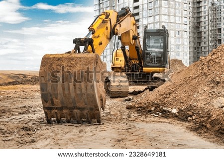 Large crawler excavator at the construction site. Close-up of an excavator bucket with the boom extended. Rental of construction equipment. Earthworks in construction