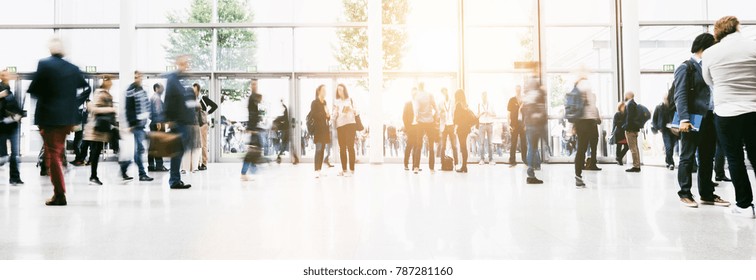 Large Crowd Of Anonymous Blurred People At A Trade Show Hall