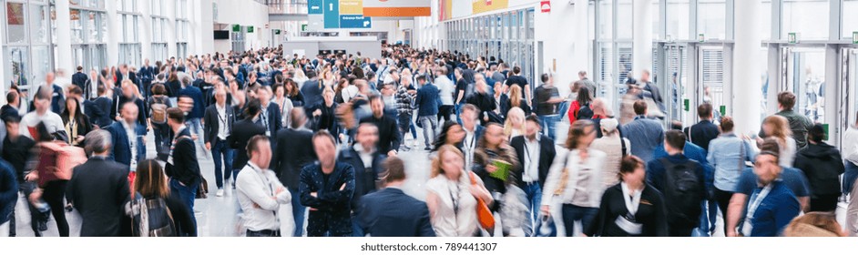 Large Crowd Of Anonymous Blurred People At A Trade Show