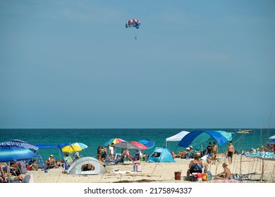 Large Crowd Of People On Sandy Ocean Beach Sunbathing And Enjoyng Vacation By The Sea. Venice, USA - June 14, 2022.