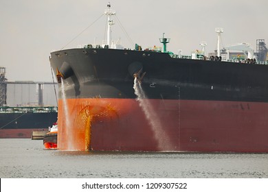 Large Crude Oil Tanker Ship Pumping Out Ballast Water When Coming Into Port