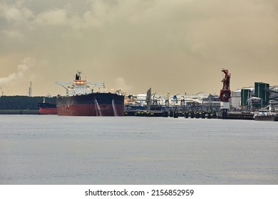 Large Crude Oil Tanker Ship Pumping Out Ballast Water Docked At The Oil Import Terminal At Rotterdam Port