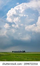 Large Cumulonimbus Storm Cloud Over A Farm On The Plains