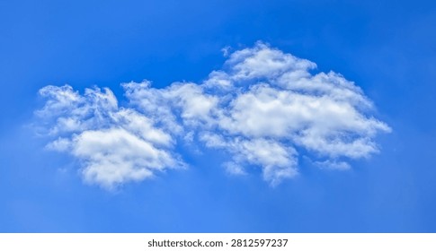 A large cumulus cloud. Clouds flowing lazily like cottony fibers against a clear, serene blue background. The sky speaks of calm, peace, and silence.