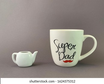 A Large Cup And A Small Kettle. A Huge Mug With The Inscription. Concept: Gift For Dad, Super Dad.