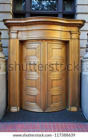 Large curved brass closed doors on a bank entrance