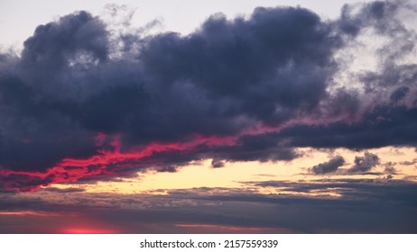 A Large Dark Cloud With A Glimmer Of Light From The Red Setting Sun, Timelapse