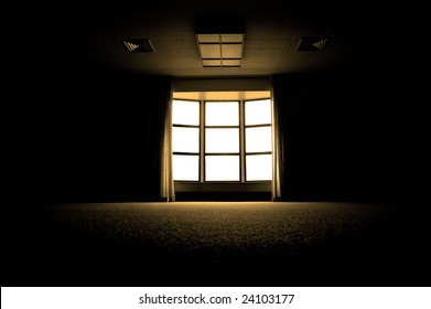 Large Dark Room With Bright Light Coming In Through Paned Window