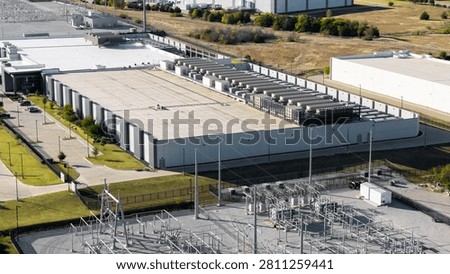 Large data center building processing information with an adjacent power substation