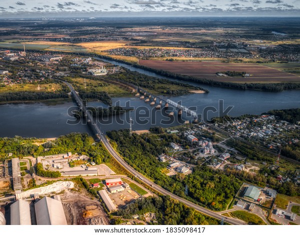 Large deep river. The river is\
crossed by two bridges. Road and railway bridges. Aerial\
view.