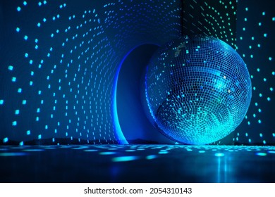 Large disco ball reflecting blue light in a dark hall for discos. Disco symbol. Copy space.