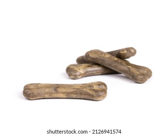 Large Dog Chew Bones For Fresh Breath. Multiple Dog Treat Sticks In Bone Shape For Strong Teeth, Better Gums And Breath. Dental Health Treats For Dogs. Selective Focus On One Bone. Isolated On White.