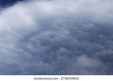 Large dramatic storm cloud with some patches showing characteristic bubble-shaped protrusionsof mammatus cloud type