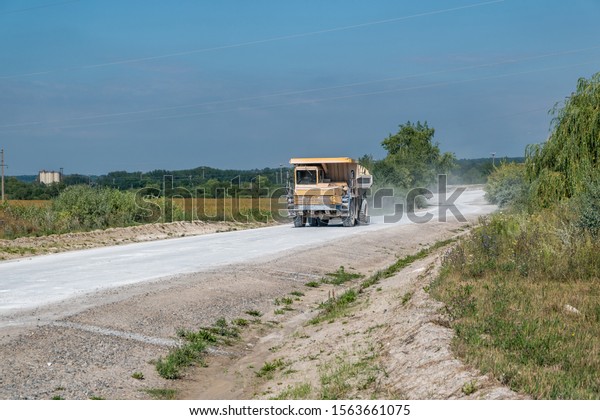 large dump truck loaded with rocks drive\
on dust road. Mining industry. Heavy\
equipment.
