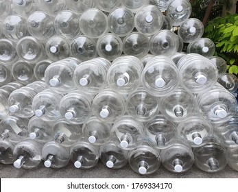 Large, empty and clear bottles when poured out of water are placed in an orderly manner in front of the office. PET bottles  5 gallon (18.9 liter) water bottle can be cleaned and reused.