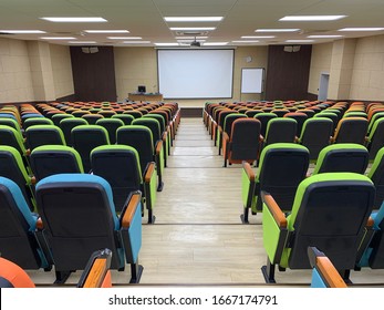 Large Empty Lecture Hall In University Classroom With Many Colors Chairs