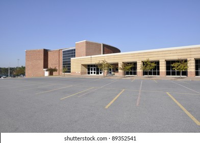 Large Empty Macadam Parking Lot By A Modern School Building