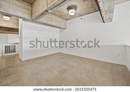 Large empty room with a white ceiling and white walls. The room is bare and empty, with no furniture or decorations