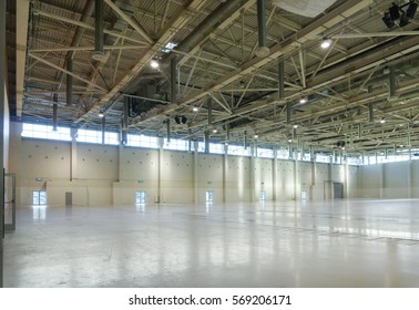 Large empty space in hangar with lights through the windows