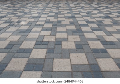 A large, empty tiled floor with a checkered pattern. The tiles are gray and white