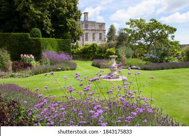 large English garden estate with flower borders and hedges and other garden furniture and design