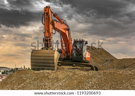 Large excavator moving gravel for the construction works of the road between Madrid and Segovia (Spain)