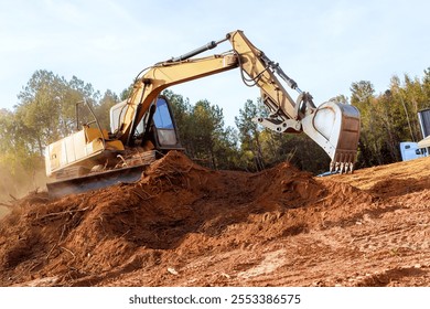 Large excavator works diligently, moving earth, debris at during construction site surrounded creating dusty atmosphere.