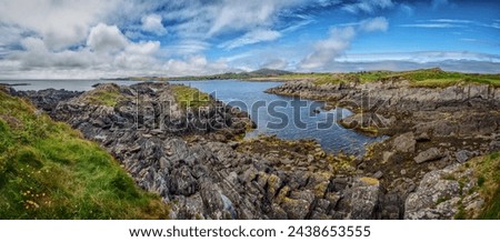 A large expanse of water enclosed by rugged rocks on the shore at Toormore, Ireland