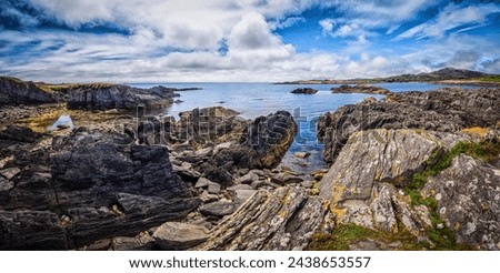 A large expanse of water enclosed by rugged rocks on the shore at Toormore, Ireland