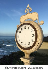 Large Exterior Clock By Ocean With No Hands, Blank Face, Sea And Clear Blue Sky In Background, Vertical, No People