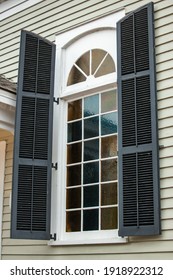 Large Exterior View Of A Window With A Curved Semi Circle Top Portion