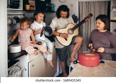 A large family with 4 children plays musical instruments and utensils. Quarantine and weekend at home in a large family. Loud and have fun. stay home