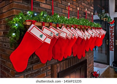 Large Family Celebrating Christmas Stockings Hanging On Mantle